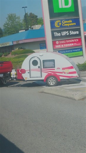 Hyundai pickup truck towing Nucamp TAG tear drop trailer on the street