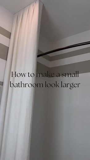 Taking shower curtains all the way from the ceiling to the floor is a great way to make your bathroom seem bigger. Keep fabric colors neutral to keep things from looking cramped and to add softness to the room. Add colorful wallpaper, and decorative bath accessories to complement your bathroom shower curtain. #design #designtips #homedecor #showercurtain #design101 #homedecor #shower #smallbathroomdesign #smallbathroom #newconstruction #interiordesign #bathroom #instabathroom #homesofinstagram #