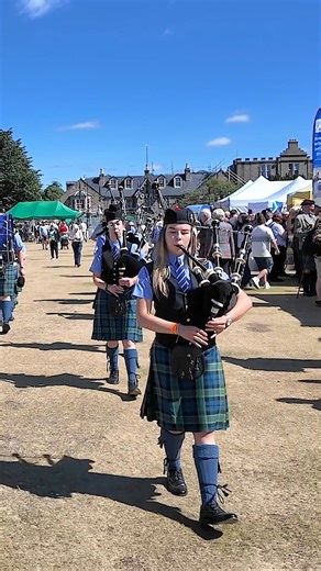 Pipe Major Euan Chapman leading Towie Pipe Band, as they marched in for their public display at the 2025 Aboyne Highland Games. These were held on Saturday 2nd August 2025 in Deeside, Aberdeenshire, Scotland, and the band were playing The Roses of Prince Charlie and the Braes of Killiecrankie. #aboynehighlandgames #marchingband #towiepipeband | Scotland's Pipe Bands