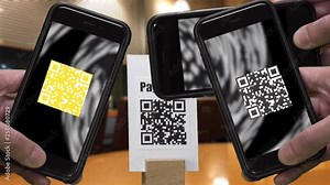 Scanning QR CODE look alike black and white pattern (CAN NOT SCAN THIS) to make a cashless payment via smartphone at the store. Colorful QR CODE flashing on smartphone screen.