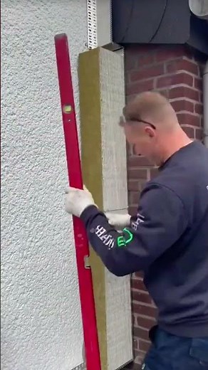 the process of installing colorful styrofoam blocks on the outer walls of the building #construction