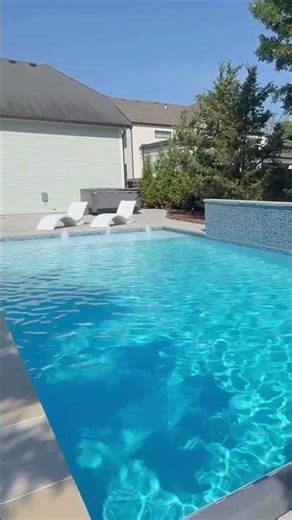 Backyard Paradise: Luxurious Pool with Water Features and Tranquil Retreat