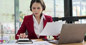 Business woman typing at modern laptop in office interior close up. Attractive young girl manager in glasses looking computer screen sitting desk. Asian woman company worker surfing internet