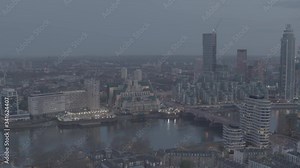 Dusk aerial zoom reveal of MI5, MI6 SIS Secret Intelligence building on River Thames. Vauxhall Cross House. British domestic intelligence drone shot London nightime. Top Secret. To be colour graded
