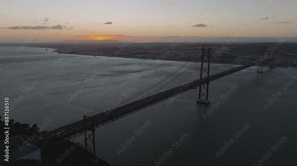 Aerial view of the 25th April Bridge - Ponte 25 de Abril - is a suspension bridge road-rail over the Tagus river that connects the city of Lisbon to the city of Almada. Panoramic view from above.