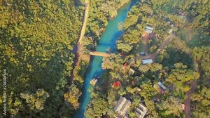 Aerial fly over of a hostel along the Cahabon River in the Guatemala jungle