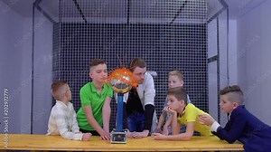 Boys explores van de graaff generator in scientific museum