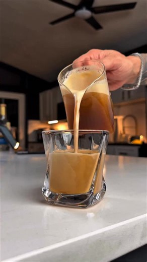 Created To Coffee on Instagram: "This drink feels like a nitro cold brew without the setup. It’s called an Aerocano, and it’s simple but not boring. Add ice, cold water, and chilled espresso to a pitcher. If you want extra depth, add a splash of vanilla syrup and a small splash of orange syrup. Steam it just until the ice melts. That’s what creates the smooth, creamy texture. Pour into a chilled glass over one large ice cube and enjoy. Refreshing, balanced, and surprisingly smooth. A perfect any