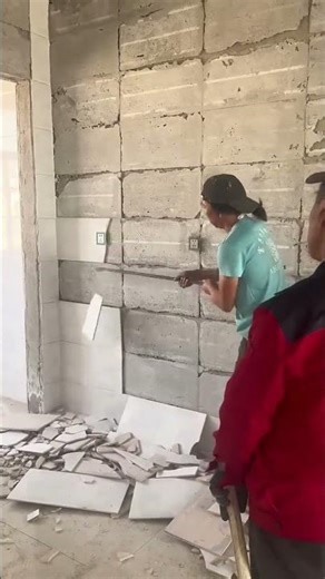 Demolition process of ceramic tiles on the wall