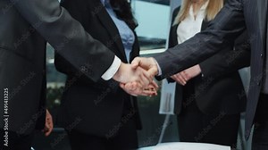 Hands of business partners gesturing during meeting, handshake after reaching agreement. Partial view of top managers making deal in office. Concept of business