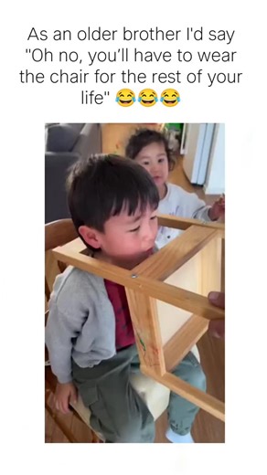 whatmemes | The post humorously reacts to a video of a toddler trapped with his head through a wooden high chair's seat frame, neck-deep and crying in... | Instagram