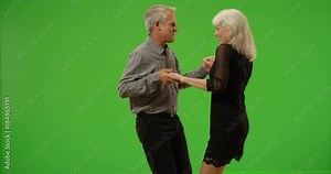 Sweet senior couple dancing together on green screen. On green screen to be keyed or composited.
