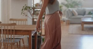 beautiful young woman getting dressed looking in mirror choosing outfit fashion choice putting on clothes enjoying positive self image feeling confident at home 4k footage