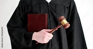 Judge in robe holding penal code book and wooden gavel closeup 4k movie slow motion. Criminal liability lawsuits concept
