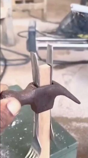 This is one way to install a handle on a hammer using a two-pronged tool.