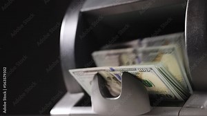 Closeup of cash counting machine counting dollar bills. Business accounting and commercial activity, american monetary units. Counting machine with US national cash money