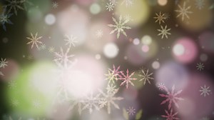 Download colorful bokeh snowflakes and unfocused bokeh light background. for free