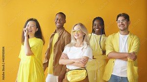 Five friendly mixed race models, wear stylish yellow clothes posing at camera. Stock Video
