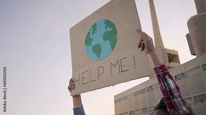 Help me poster claim during a street protestor for climate change. Slow motion.