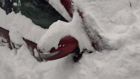 Heavy overnight snowfall buries car and streets in Minakami, Japan