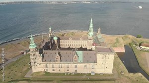 Cinematic 4K aerial drone bird's-eye orbit footage of Kronborg Slot Castle, one of UNESCO's World Heritage sites, Helsingør city and Marina in in Denmark