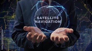 Male hands activate a conceptual holographic text Satellite navigation. Businessman in a suit with a hologram of planet Earth on a background of a futuristic wireframe city