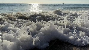 transparent blue sea waves on clear day, oceans natural motion at beach destination, scene attracting tourists seeking seaside relaxation and marine exploration, white big sea foam.