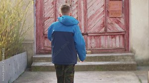 An angy teenager speaks by mobile and smashes a mobile phone