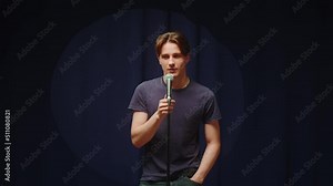 StandUp cafe, comedy concert. Man telling jokes on stage close-up. Male comedian speaking with audience using microphone, humorous monologue. Mentor coach training.