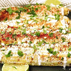 Elote or Mexican street corn is grilled corn on the cob lathered in creamy, cheesy goodness that is so irresistible! If you’ve never had it, you’ll wonder how you ever lived without it! RECIPE: https://ohsweetbasil.com/authentic-mexican-corn-elote-and-my-top/ | Sweet Basil