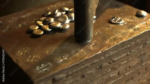 Blacksmith Strikes an Antique Inscription Symbol into a Round Piece of Metal. A Blacksmith is a Metalsmith Who Creates Objects Primarily from Wrought Iron or Steel, but Sometimes From Other Metals.