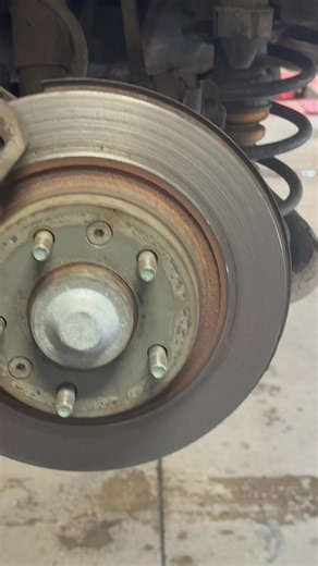 This is what happens when “I’ll do the brakes later” turns into “why does my car sound like a train wreck?” In the video, the left rear outer brake pad and backing plate are completely gone. The caliper is grinding directly on the rotor, turning it into a very expensive, very dangerous noise machine. If your ride is squealing, grinding, or pulsing when you brake, that’s not a suggestion, that’s a warning. Get it inspected before your brakes start machining the rotor for free. #CarMaintenance #Br