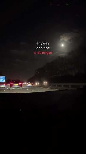 Nighttime Highway Scene with Illuminated Cars