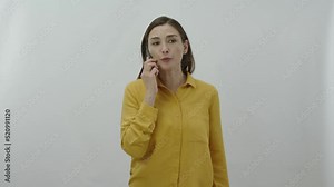 Angry woman shouting at smartphone isolated on white background. Young woman yelling at the person on the phone. Angry woman quarreling with her boyfriend or husband.