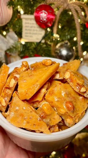 This Peanut Brittle is the easiest to make and I have to thank Wyse Guide (Kaleb) for the recipe! If you’ve ever been afraid of it, I hope you give it a try. I’m so glad I did 4 years ago and I’ve been making it every year since! Peanut Brittle: 2 cups granulated sugar 1/2 cup hot water 2 cups (1 - 16 oz bottle) light Karo syrup 2 Tbsp. unsalted butter 2 cups raw peanuts 1 tsp. vanilla 2 tsp. baking soda You will need a candy or digital thermometer for this recipe. Lightly butter a 10x15 baking 