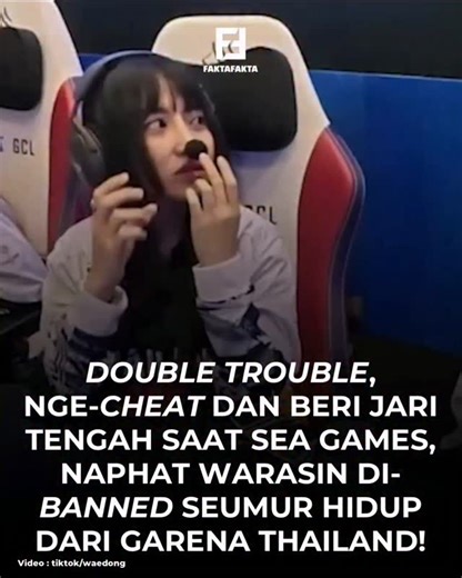 FAKTAFAKTA on Instagram: "Naphat Warasin, yang lebih dikenal dengan nama panggung Tokyogurl, merupakan atlet esports profesional Arena of Valor (AoV) asal Thailand yang bernaung di bawah tim ternama Talon Esports. Keberaniannya melakukan tindakan fatal di panggung sebesar SEA Games 2025, mulai dari penggunaan perangkat lunak pihak ketiga yang ilegal (cheat) hingga aksi provokatif mengacungkan jari tengah ke kamera saat siaran langsung, diduga muncul dari tekanan kompetisi yang tinggi atau perila