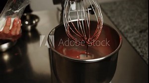 The process of preparing dough for a sponge cake. The ingredients of the sponge cake are mixed in a blender. The concept of confectionery preparation of products and cakes