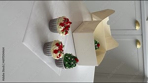 woman prepares cake and pastries. fold muffins in a box. vertical video. High-quality shooting in 4K format.