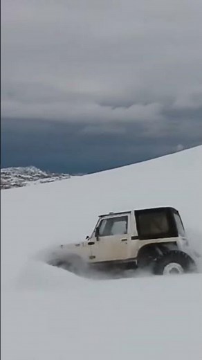 Suzuki Samurai in deep snow