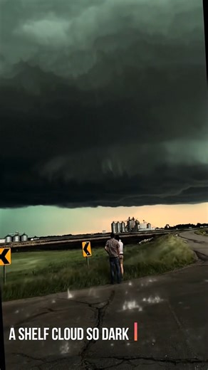 That’s not a normal storm cloud .. it’s a shelf cloud rolling in like a giant black wall, the kind that turns daylight into a warning. The air goes weirdly quiet, the wind flips direction, and everything in you says “move… now.” Even the road curves away like it knows what’s coming. Somewhere in Tornado Alley (USA). | AstroNature