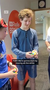4.1K views · 62 reactions | “Should I do it blindfolded?” Queensland’s champion speedcubers Charlie Eggins and Toby Seufert teach Brisbane Lord Mayor Adrian Schrinner how to solve a Rubik’s cube. Check out the full story: https://www.abc.net.au/news/2023-10-05/rubiks-cube-prodigies-win-national-championship/102934578 | ABC Brisbane | Facebook