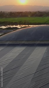 Covered lagoon digester for biogas production from poultry farm. Vertical video.