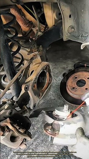 The technical process of removing a worn rear wheel hub and bearing assembly.