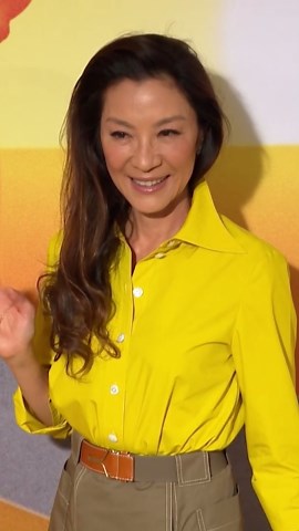 Michelle Yeoh radiates confidence in a vibrant yellow ensemble at the premiere event