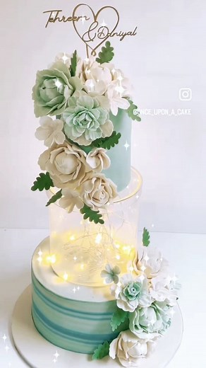 2.1K views · 12 reactions | One of our very unique Wedding Cakes in Ice Blue shades 朗 All those flowers are lovingly moulded with hands and put together for this one of a kind design. Oh yes those are Fairy lights inside! My very favorite element. As the weather gets better in the city, the summer wedding season has begun and we are all geared up to create the very best for you  Very few slots remaining for July. DM us ✨ | Once Upon A Cake | Facebook
