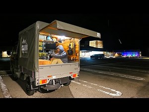 Sleeping on the roadside in the bed of a small truck