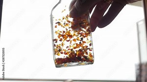 tincture of amber, pieces of amber in a bottle, slow motion