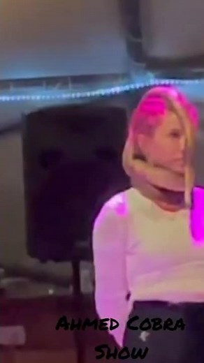 Cobra snake wraps around the neck of the girl and sleeps on the girl's head