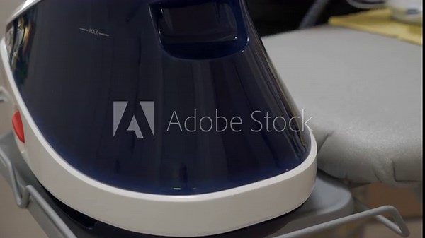 The steam generator base unit heats water on the ironing board stand. As it operates, a mechanical pump rattles while pushing water, and pressurized vapor is released with a loud hissing sound.