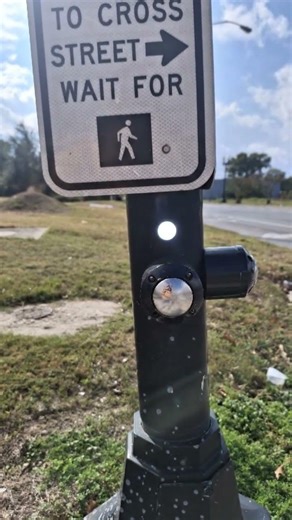 Crosswalk button lights up, then speaks 'Walk signal activated!'